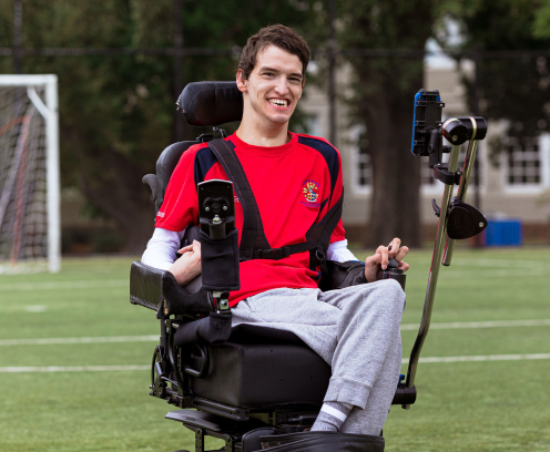 Noah looking happy on the soccer field in his wheelchair