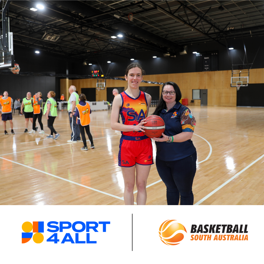 Sport4All's Inclusion Coach Kelly with a Basketball SA athlete, both holding a basketball and smiling at the camera. In the background, some people are playing basketball, but they are blurred. The Sport4All logo and Basketball SA logo is shown at the bottom.