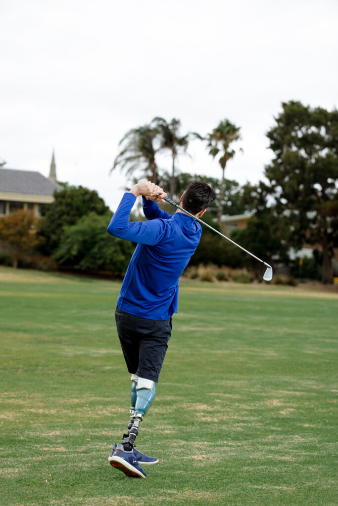 A man with disability playing golf.