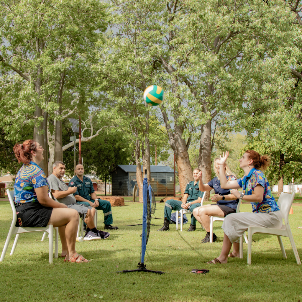 Participants playing seated volleyball.