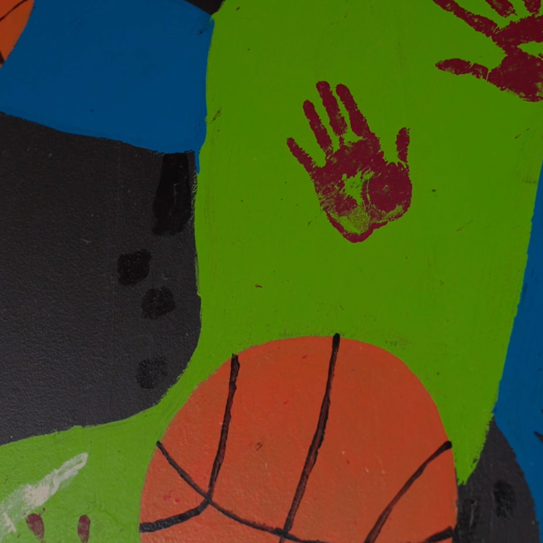 An image of artwork at one of the facilities in kimberley. It shows range of colours, hand printed and basketball.