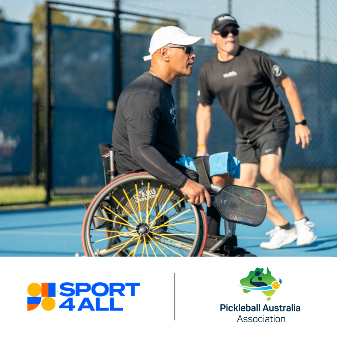 A person in a wheelchair is holding a pickleball racket. He is wearing a white cap and sunglasses, looking away from the camera with a focused expression. In the background, another person is running backwards. This person is wearing a black shirt, black shorts, sunglasses, and a black cap. Sport4All logo and Picklebakk Australia Association logo is displayed at the bottom of the image.