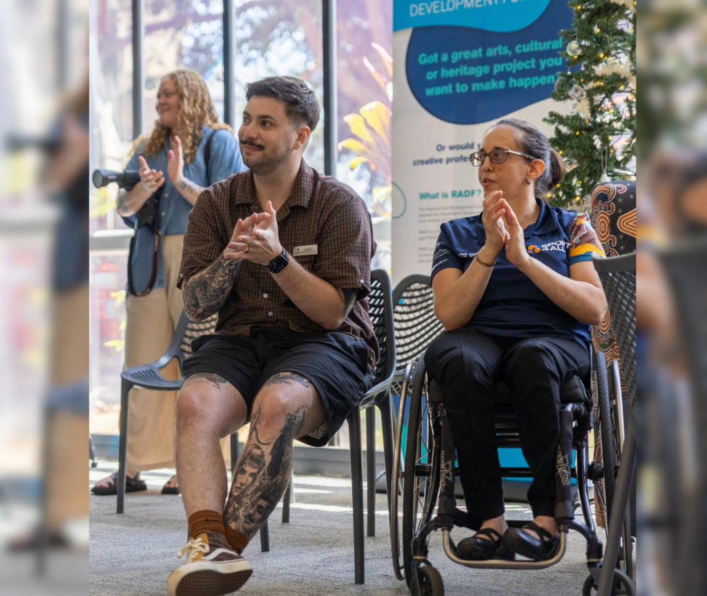 Sport4All Inclusion Coach, Kristy is on the wheelchair wearing a Sport4All polo next to another person seated next to Kristy.