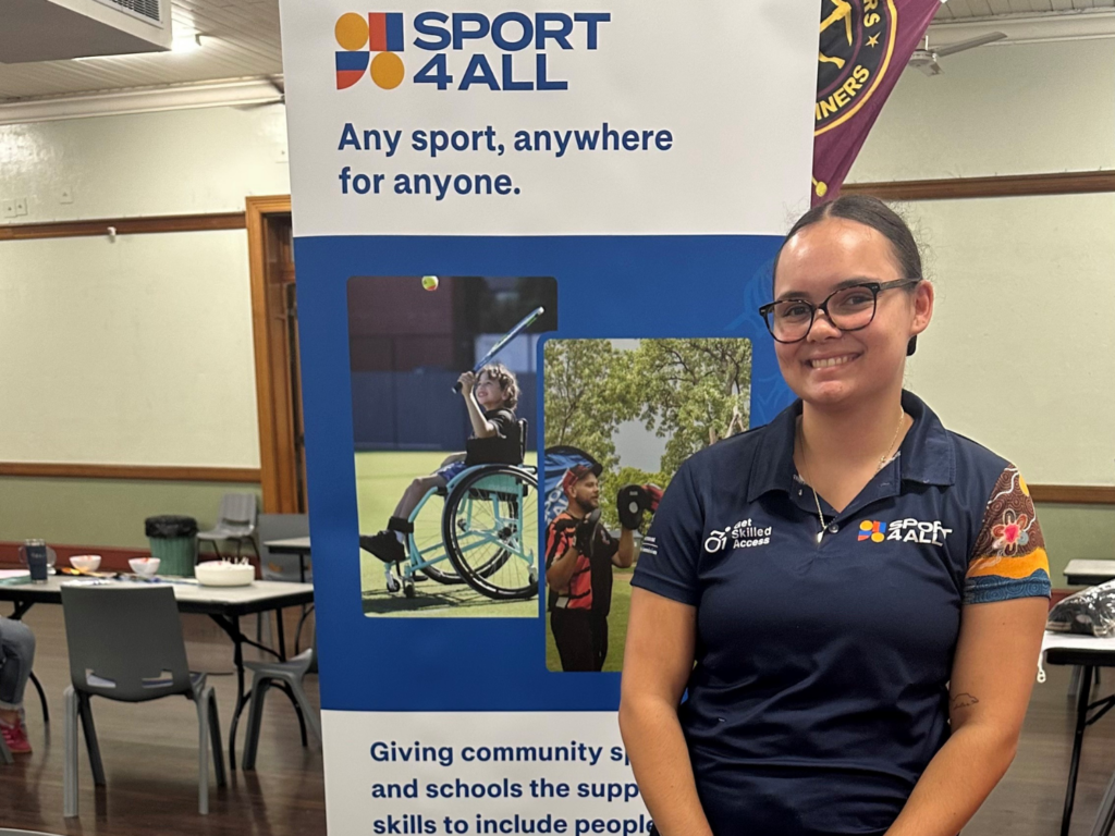 Sport4All Inclusion Coach Shamika Pryor-Woods at an event, behind her is the Sport4All pull up benner.