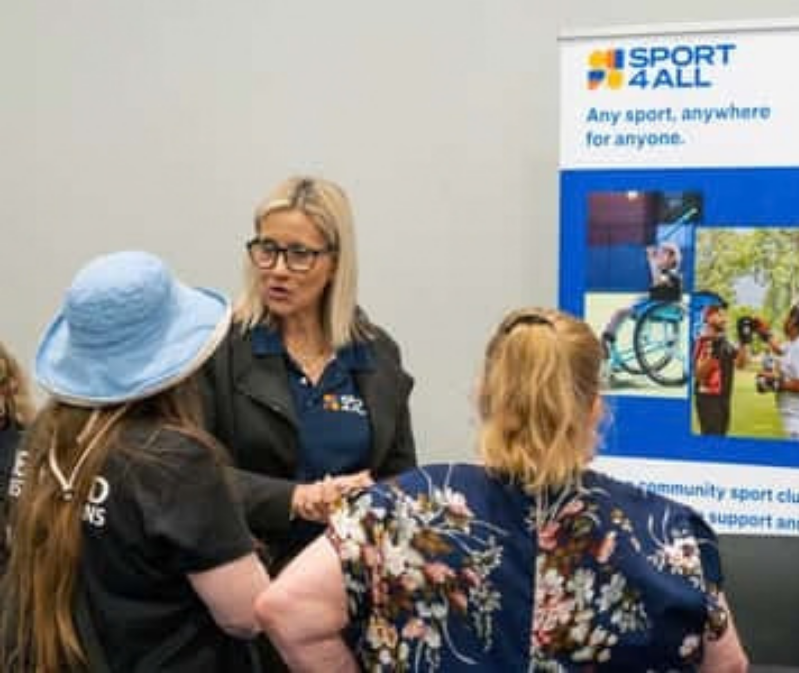 Community members visit a Sport4All information stall at an event.